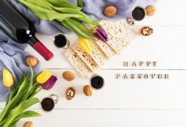 festive-background-with-traditional-treats-jewish-passover-holiday-white-wooden-background-with-happy-passover-letters-flowers_425936-4797